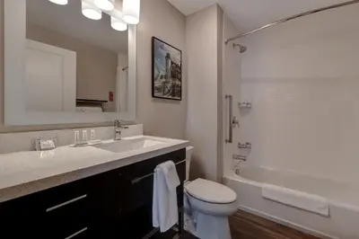 a bathroom with a sink and a toilet and a tub at TownePlace Suites by Marriott Monroe in Monroe