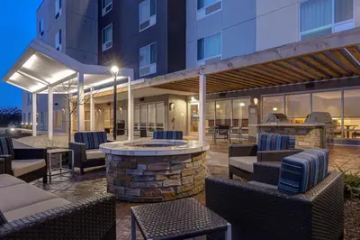a patio with chairs and a fire pit in a building at TownePlace Suites by Marriott Monroe in Monroe