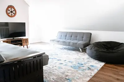 a living room with a couch and a chair at Cordova Farmhouse - 7 Minutes from the Ark! in Williamstown