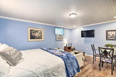 a bedroom with blue walls and a bed and a tv at Updated Williamstown Apartment with Kitchen! in Williamstown
