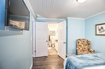 a bedroom with blue walls and a bed with a chair at Updated Williamstown Apartment with Kitchen! in Williamstown