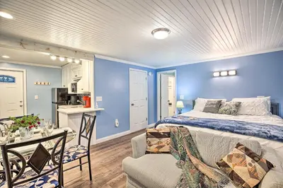 a bedroom with blue walls and a bed and a kitchen at Updated Williamstown Apartment with Kitchen! in Williamstown