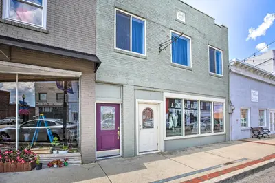 a building with a purple door on a street at Updated Williamstown Apartment with Kitchen! in Williamstown