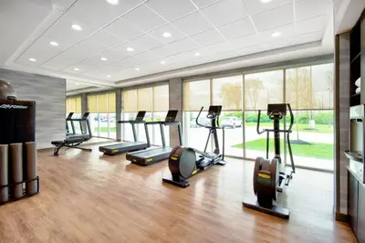a gym with several treadmills and elliptical machines at Fairfield by Marriott Inn & Suites Cincinnati North West Chester in West Chester