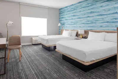 a hotel room with two beds and a blue wall at TownePlace Suites By Marriott Dayton Wilmington in Wilmington
