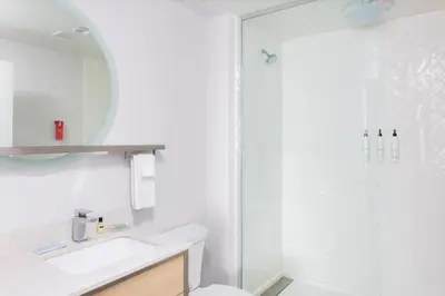 a white bathroom with a sink and a shower at TownePlace Suites By Marriott Dayton Wilmington in Wilmington