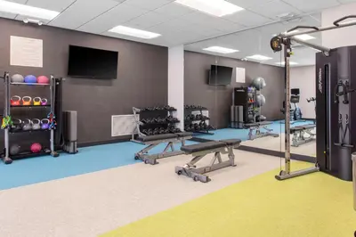 a fitness room with a gym with tread machines at TownePlace Suites By Marriott Dayton Wilmington in Wilmington