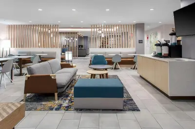 a lobby with couches and chairs and tables at TownePlace Suites By Marriott Dayton Wilmington in Wilmington