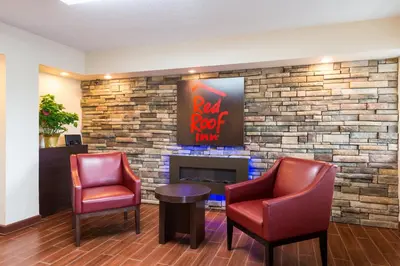 a waiting room with two chairs and a fireplace at Red Roof Inn Marion, IN in Marion