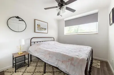 a bedroom with a bed and a ceiling fan at Georgetown Villas 1-1b Close to Cleveland Airport and the Rocky River Valley in Fairview Park