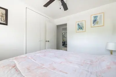a white bedroom with a large bed and a ceiling fan at Georgetown Villas 1-1b Close to Cleveland Airport and the Rocky River Valley in Fairview Park