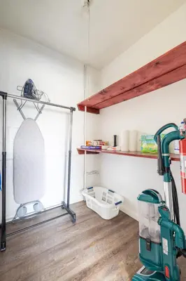 a cleaning room with a vacuum and a shelf at Georgetown Villas 1-1b Close to Cleveland Airport and the Rocky River Valley in Fairview Park