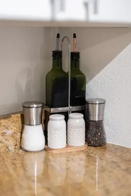 a counter with two bottles and other items on it at Georgetown Villas 1-1b Close to Cleveland Airport and the Rocky River Valley in Fairview Park