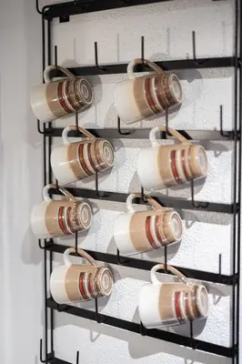 a bunch of coffee cups hanging on a wall at Georgetown Villas 1-1b Close to Cleveland Airport and the Rocky River Valley in Fairview Park