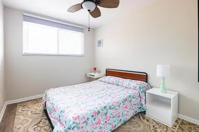 a bedroom with a bed and a ceiling fan at Georgetown Villas 3-2c Close to Cleveland Airport and Fairview Hospital ideal for long stays! in Fairview Park
