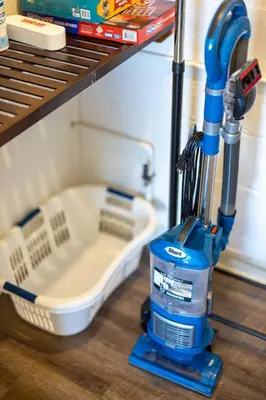 a blue vacuum cleaner sitting on a shelf at Georgetown Villas 3-2c Close to Cleveland Airport and Fairview Hospital ideal for long stays! in Fairview Park