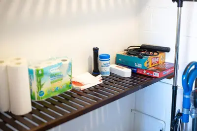 a shelf with toilet paper and other items on it at Georgetown Villas 3-2c Close to Cleveland Airport and Fairview Hospital ideal for long stays! in Fairview Park