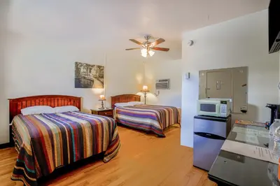 a hotel room with two beds and a microwave at Cadiz Motel by OYO on route 250 in Cadiz