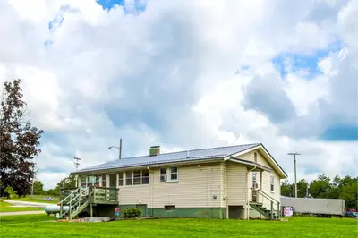 a house with a solar panel on top of it at Cadiz Motel by OYO on route 250 in Cadiz