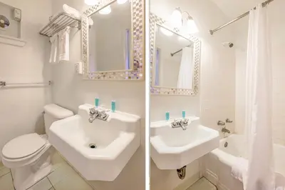 a white bathroom with a sink and a toilet at Cadiz Motel by OYO on route 250 in Cadiz