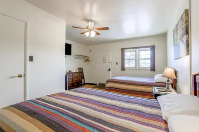 a bedroom with two beds and a ceiling fan at Cadiz Motel by OYO on route 250 in Cadiz