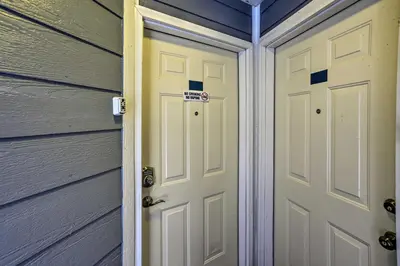 a pair of doors in a garage next to a house at Resort-Style Condo with Lake-View Balcony! in Put-in-Bay