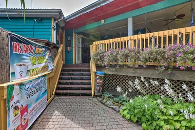 a porch of a house with flowers and plants at Resort-Style Condo with Lake-View Balcony! in Put-in-Bay