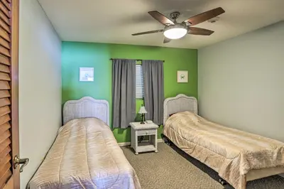 two beds in a room with green walls at Resort-Style Condo with Lake-View Balcony! in Put-in-Bay