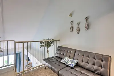a living room with a leather couch in a room at Resort-Style Condo with Lake-View Balcony! in Put-in-Bay