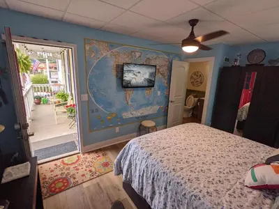 a bedroom with a bed and a map on the wall at The Estate Studio in Downtown Milford in Milford