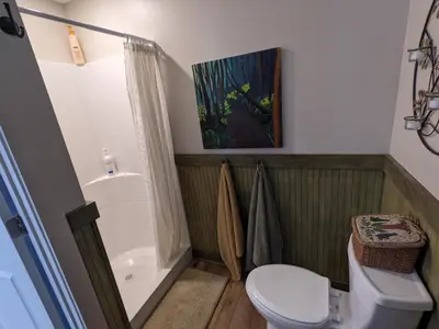 a bathroom with a white toilet and a shower at The Estate Studio in Downtown Milford in Milford