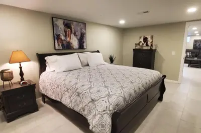 a bedroom with a large bed and a table with a lamp at Cindy's Super Ranch Home in West Chester