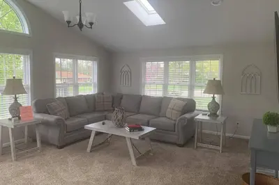 a living room with a couch and two tables at Cindy's Super Ranch Home in West Chester