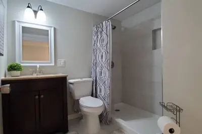 a bathroom with a toilet and a shower curtain at Cindy's Super Ranch Home in West Chester