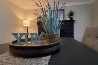 a dining room table with a sign that says yum at Cindy's Super Ranch Home in West Chester