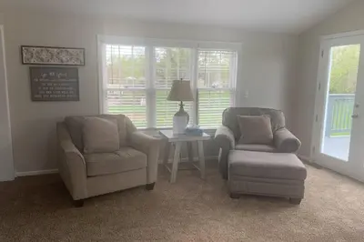 a living room with two chairs and a table at Cindy's Super Ranch Home in West Chester