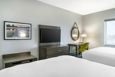 a hotel room with a bed and a flat screen tv at Comfort Inn & Suites Adrian in Adrian
