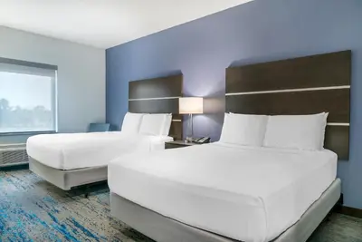 a hotel room with two beds and a window at Comfort Inn & Suites Adrian in Adrian