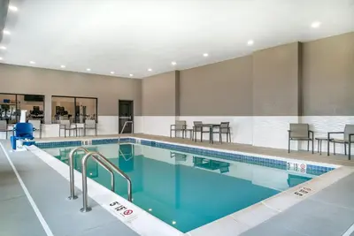 a large swimming pool with blue water at Comfort Inn & Suites Adrian in Adrian