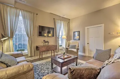 a living room with two couches and a table at Quaint Apartment in Historic Georgetown! in Georgetown