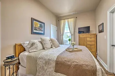 a bedroom with a bed with a television and a dresser at Quaint Apartment in Historic Georgetown! in Georgetown
