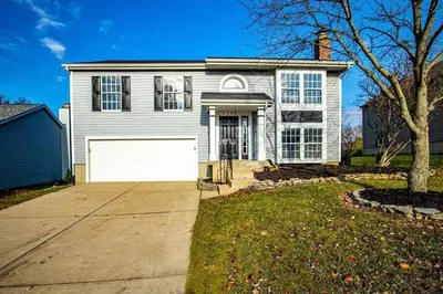 a large white house with a white garage at Lacinda's Cozy Home in Beckett Ridge