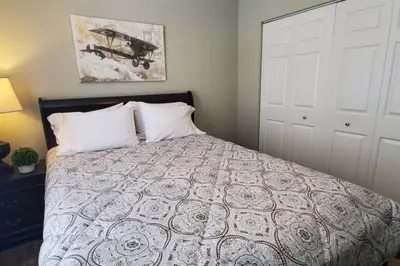 a bedroom with a large bed with white pillows at Lacinda's Cozy Home in Beckett Ridge