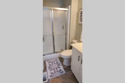 a bathroom with a toilet and a shower at Lacinda's Cozy Home in Beckett Ridge