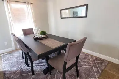 a black dining room table with chairs and a mirror at Lacinda's Cozy Home in Beckett Ridge