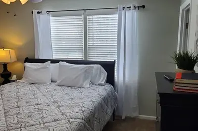 a bedroom with a bed with white pillows and a window at Lacinda's Cozy Home in Beckett Ridge