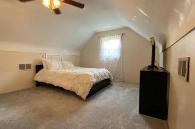 a bedroom with a bed and a ceiling fan at Nikki's House in Cincinnati