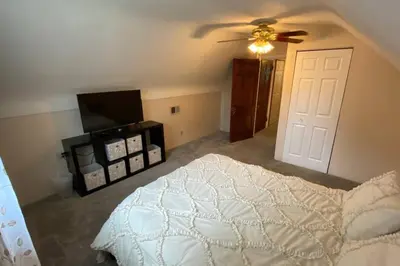 a bedroom with a bed and a ceiling fan at Nikki's House in Cincinnati