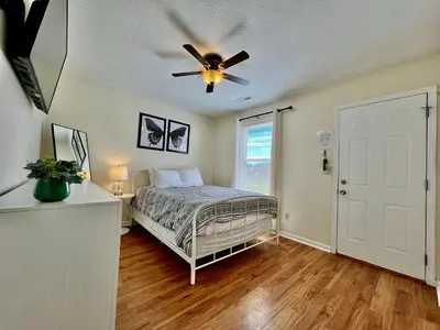 a bedroom with a bed and a ceiling fan at Lennie's House Near the Lake in Monroe