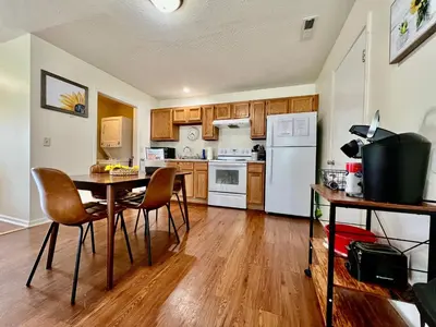 a kitchen with a table and chairs and white appliances at Lennie's House Near the Lake in Monroe
